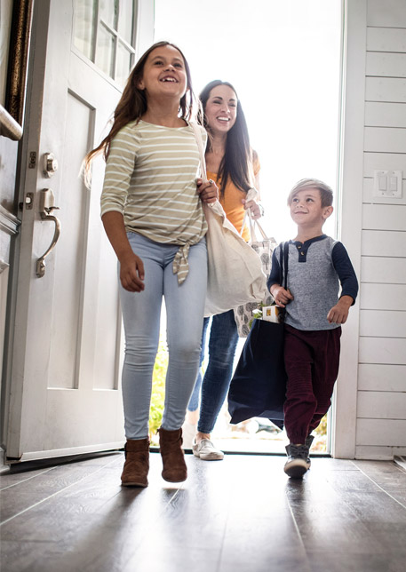 family walking through door