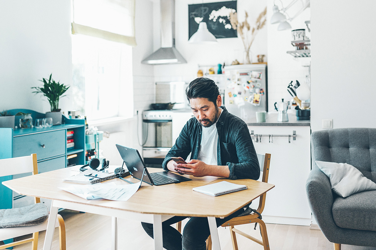 man with computer and mobile phone