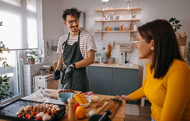 couple cooking dinner in their newly renovated kitchen