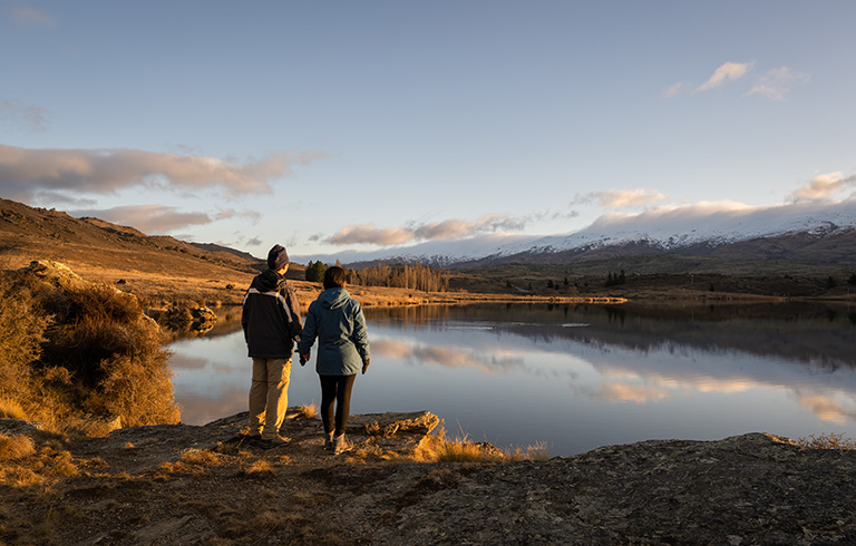 two people looking out at a lake