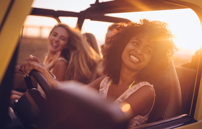 two teen girls driving in a car