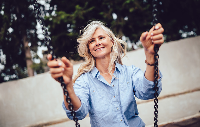 elderly woman on a swing