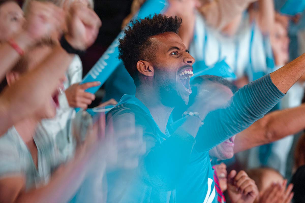 Hockey fan cheering in a stadium