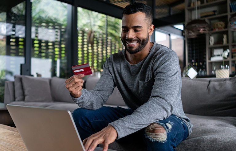 Man holding a red credit card