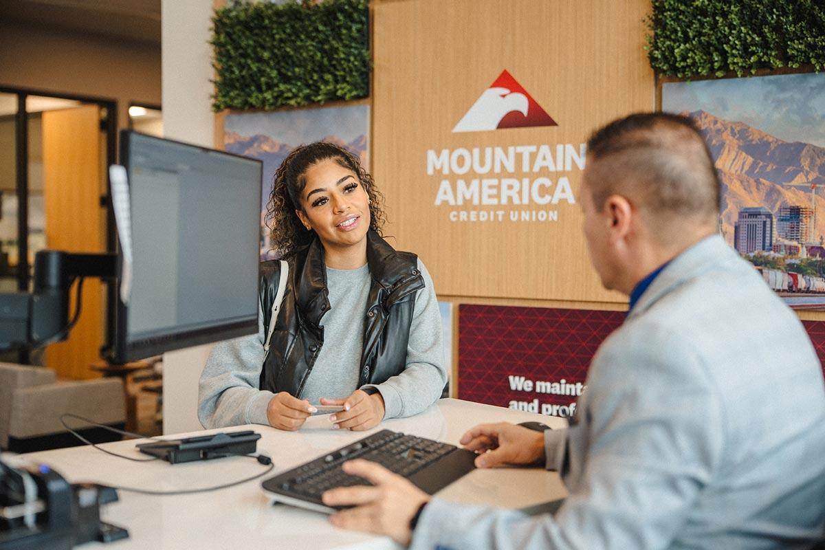 Employee helping member with her card