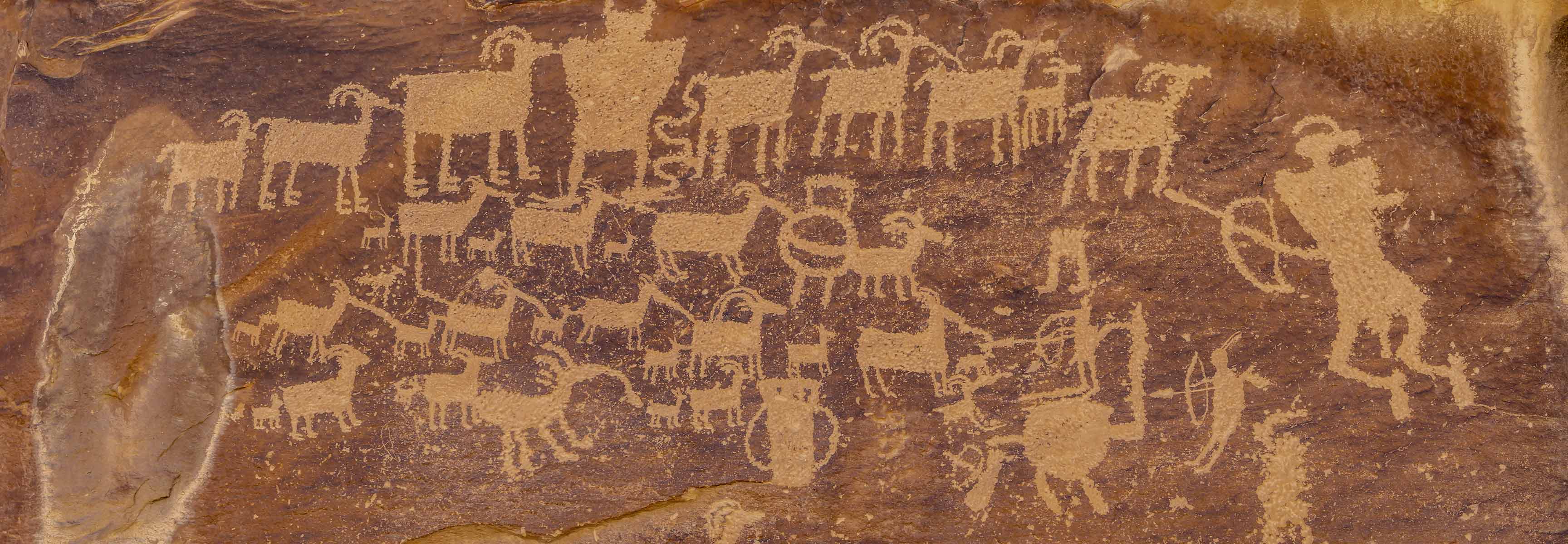 Petroglyphs on red rock wall