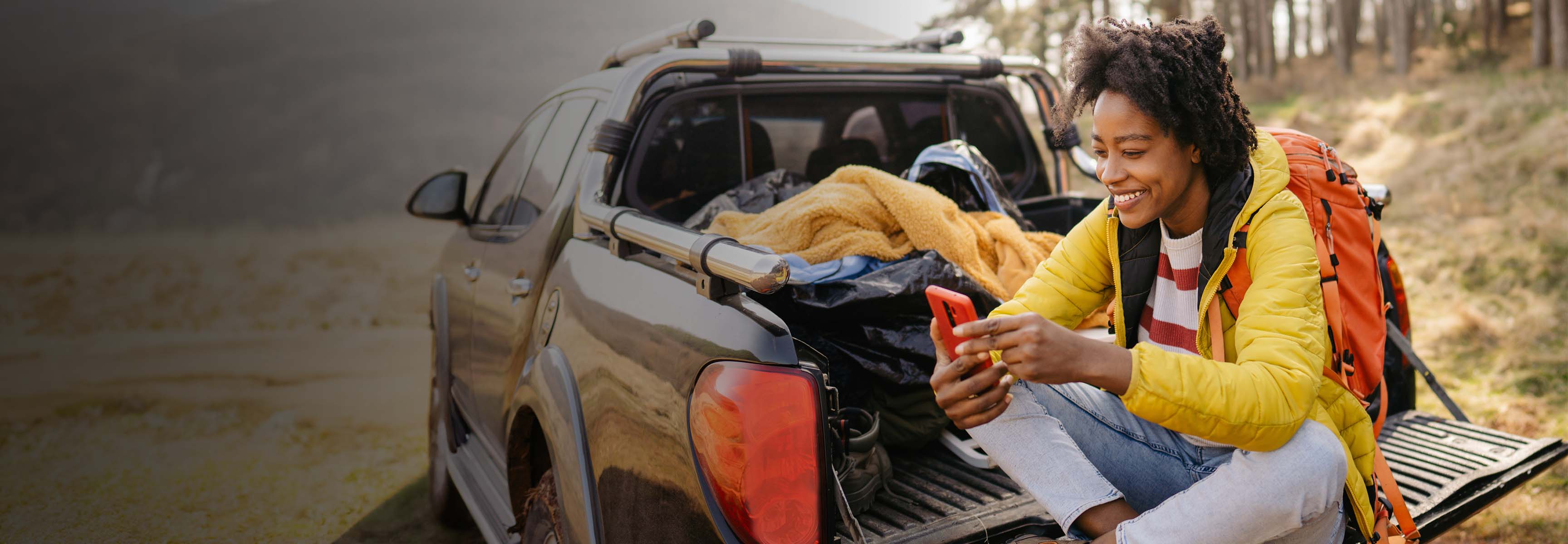 woman sitting in her truck bed