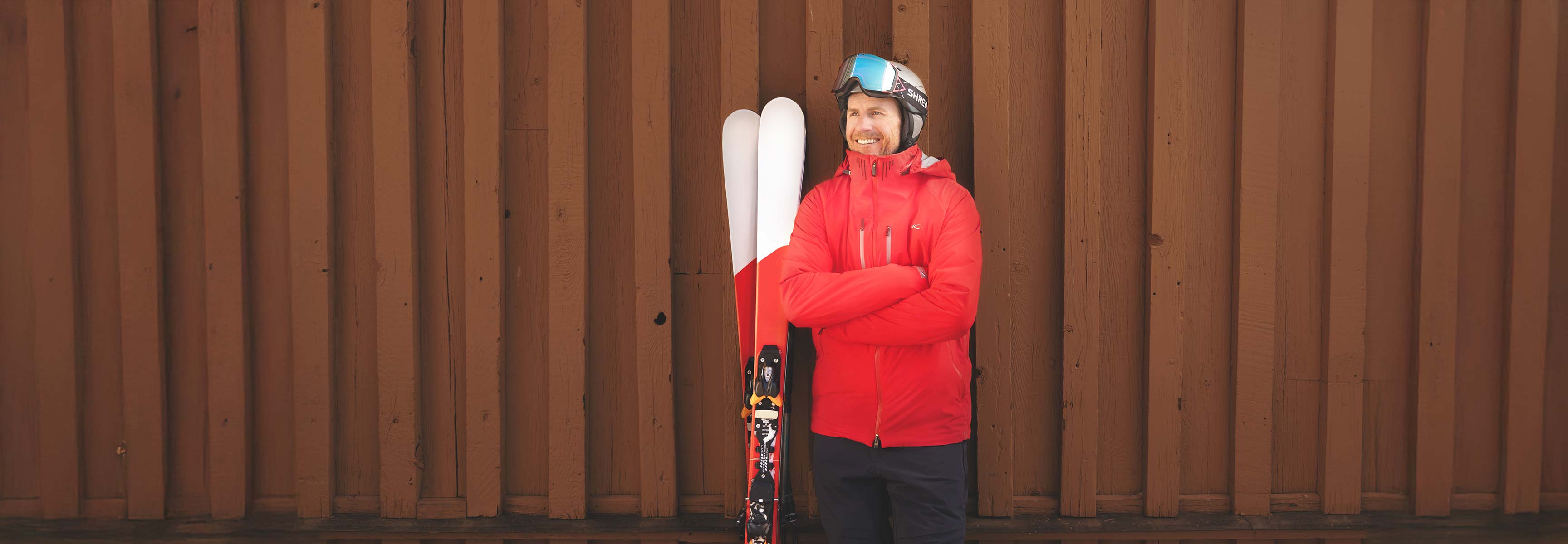 Man standing by a pair of skis