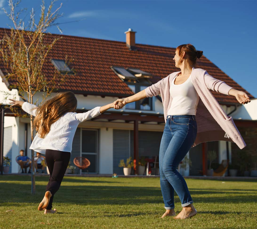 Mother and daughter playing in their yard