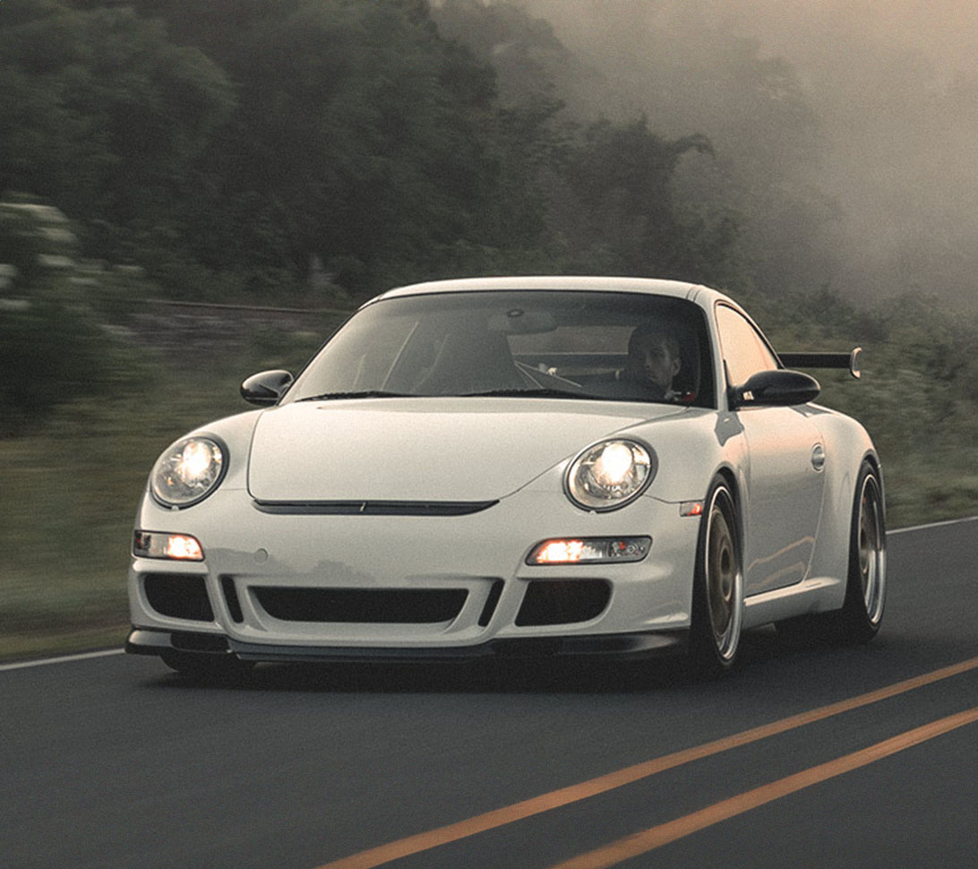 white car driving on the road