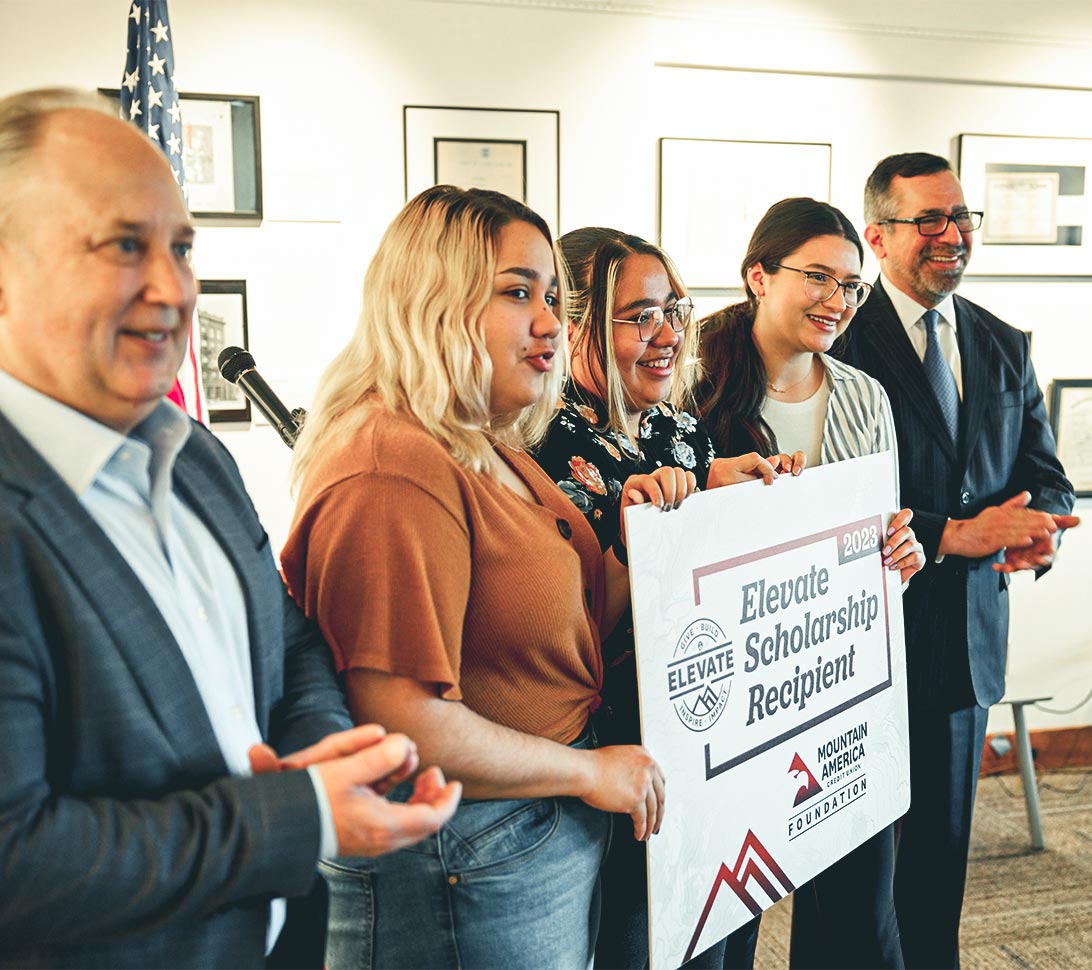 Teens holding scholarship award