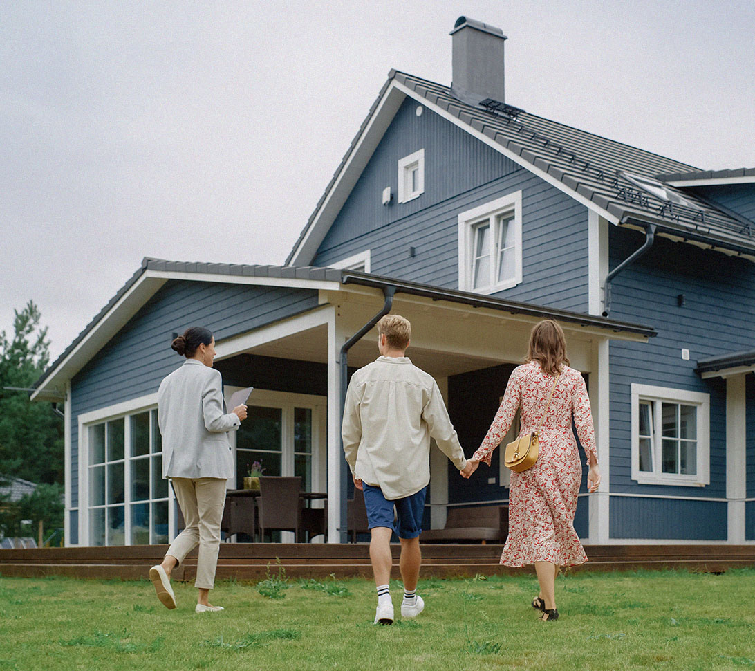 young couple looking at blue home