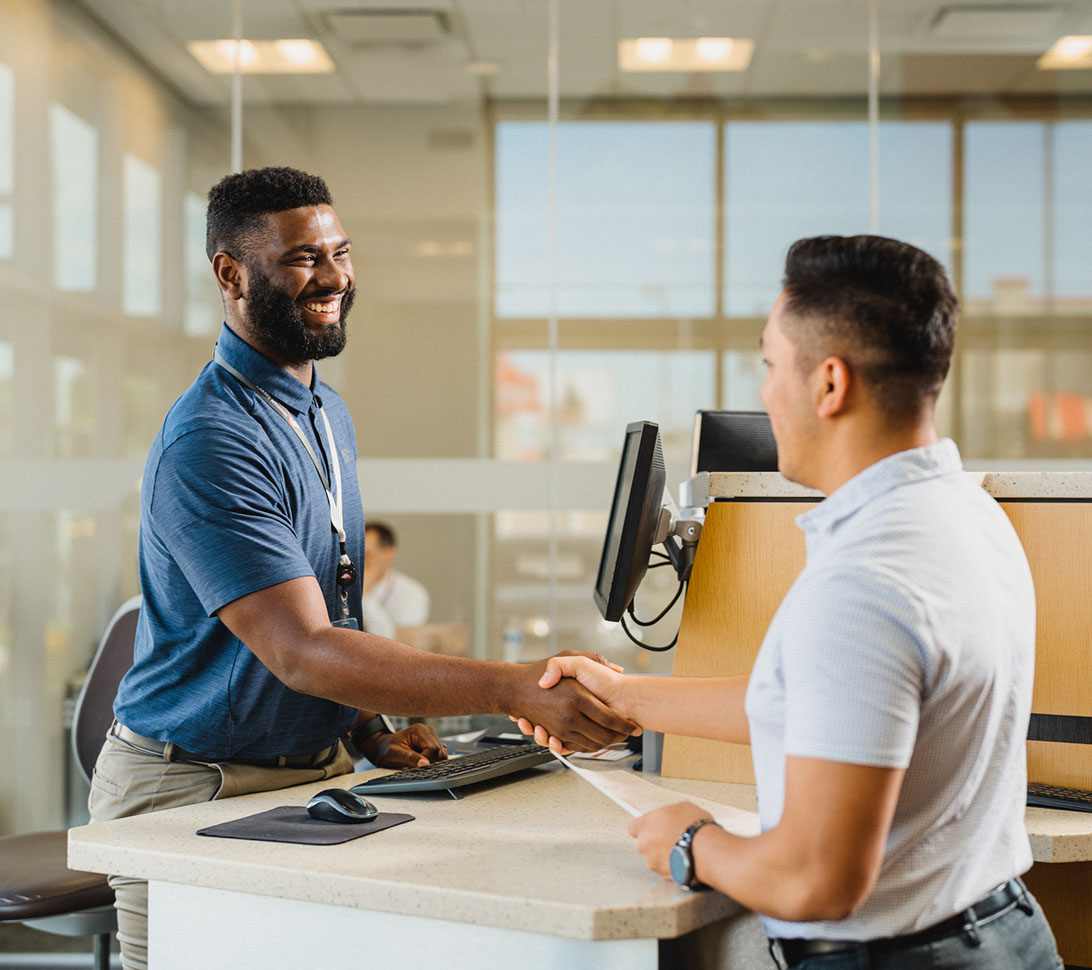 MACU employee shaking hands with a member