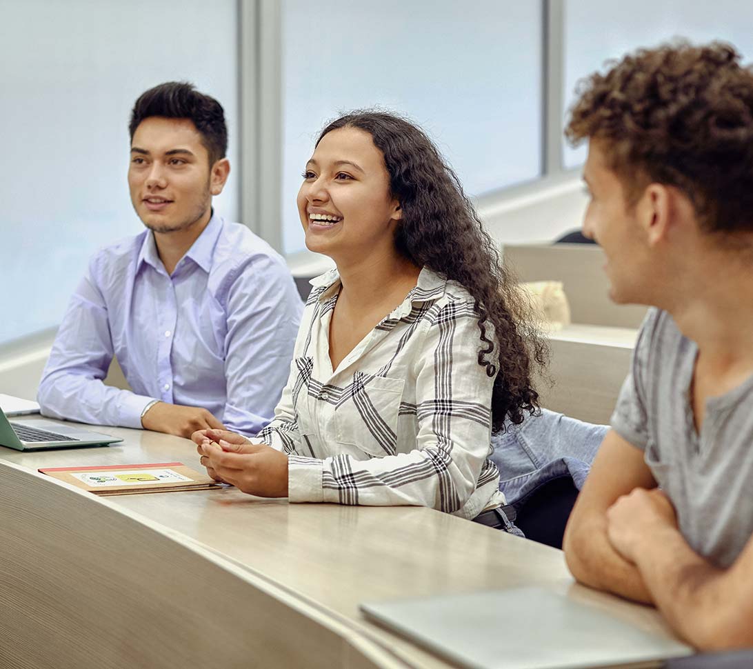 Three students in a lecture hall
