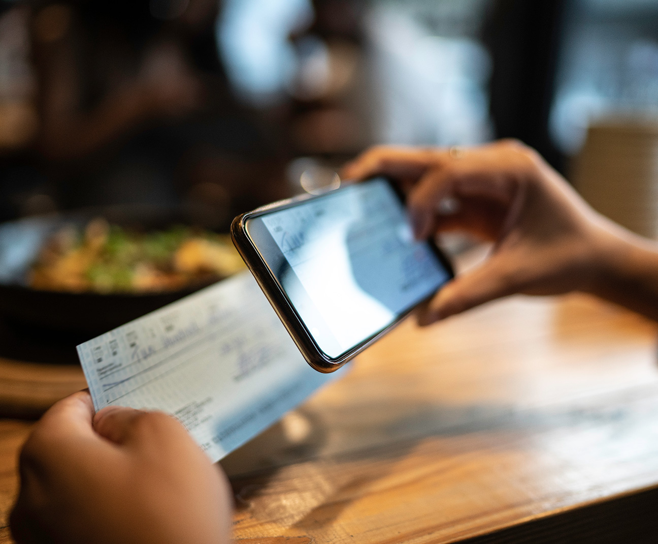 person depositing a check on their phone