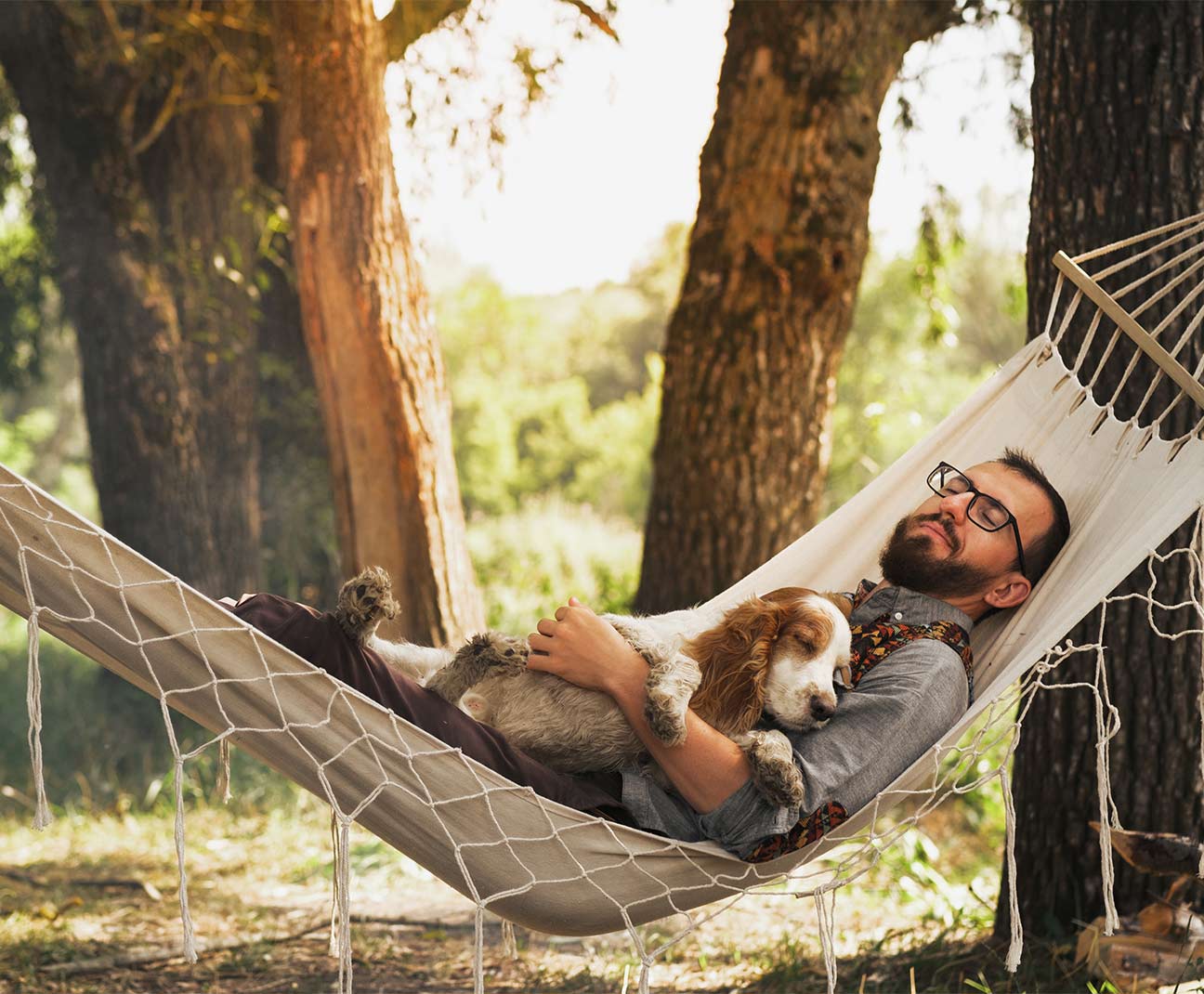 man relaxing in hammock