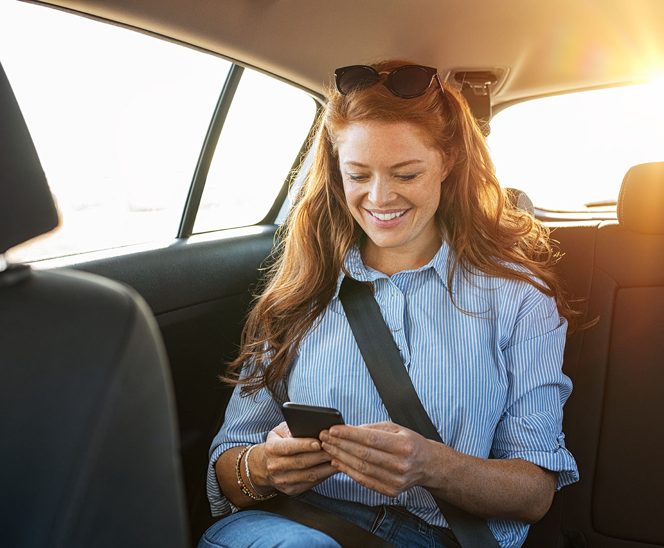 woman on her phone in the car