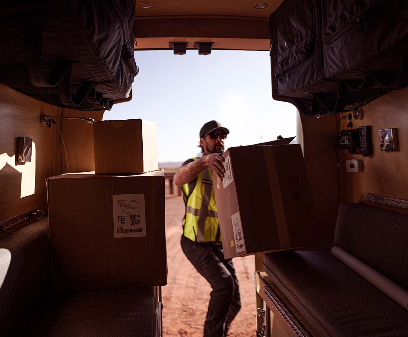 Delivery man unpacking boxes from his van