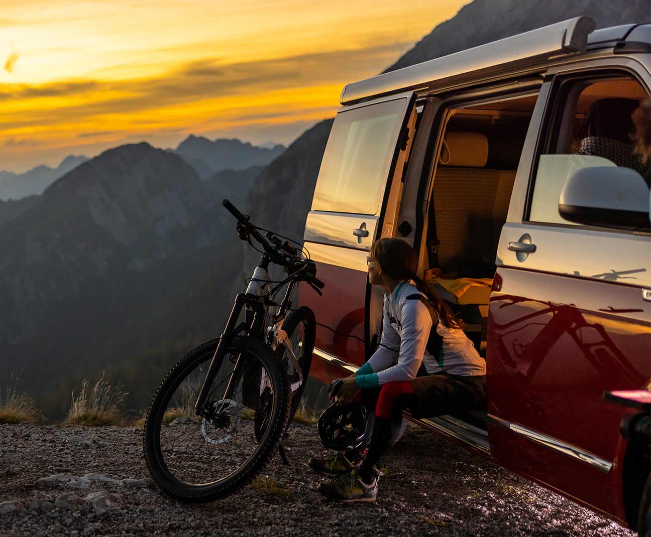 mountain biker resting by her van