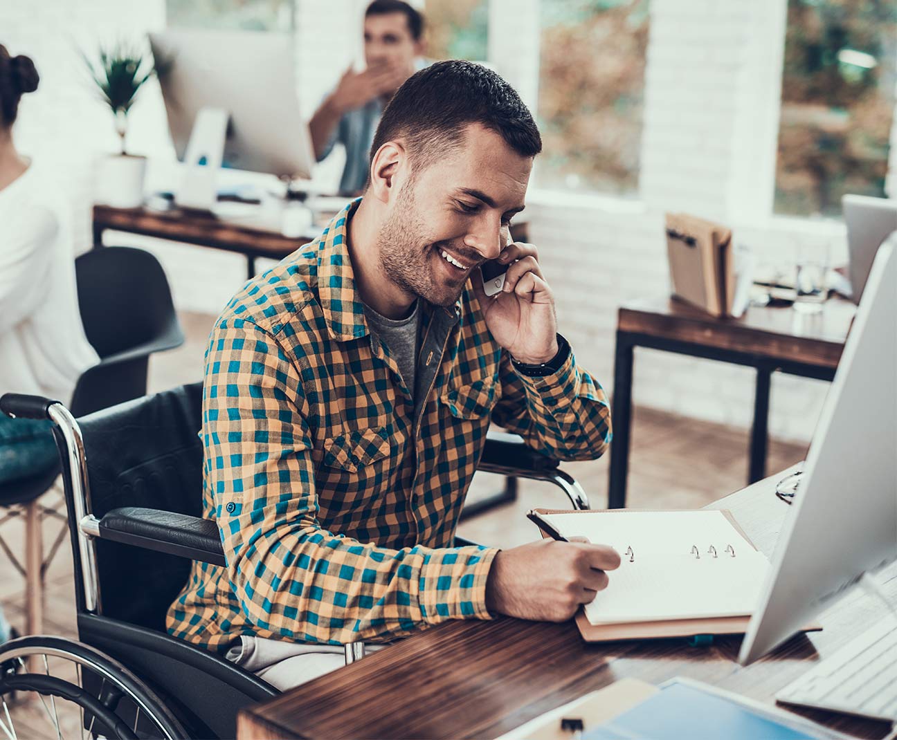 Man on the phone while working on his computer