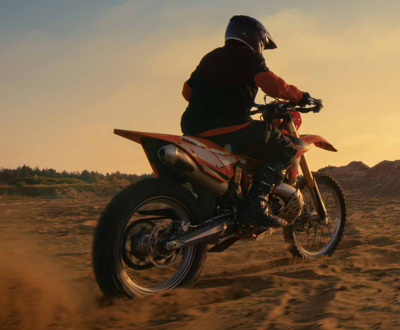 person riding dirtbike in sand
