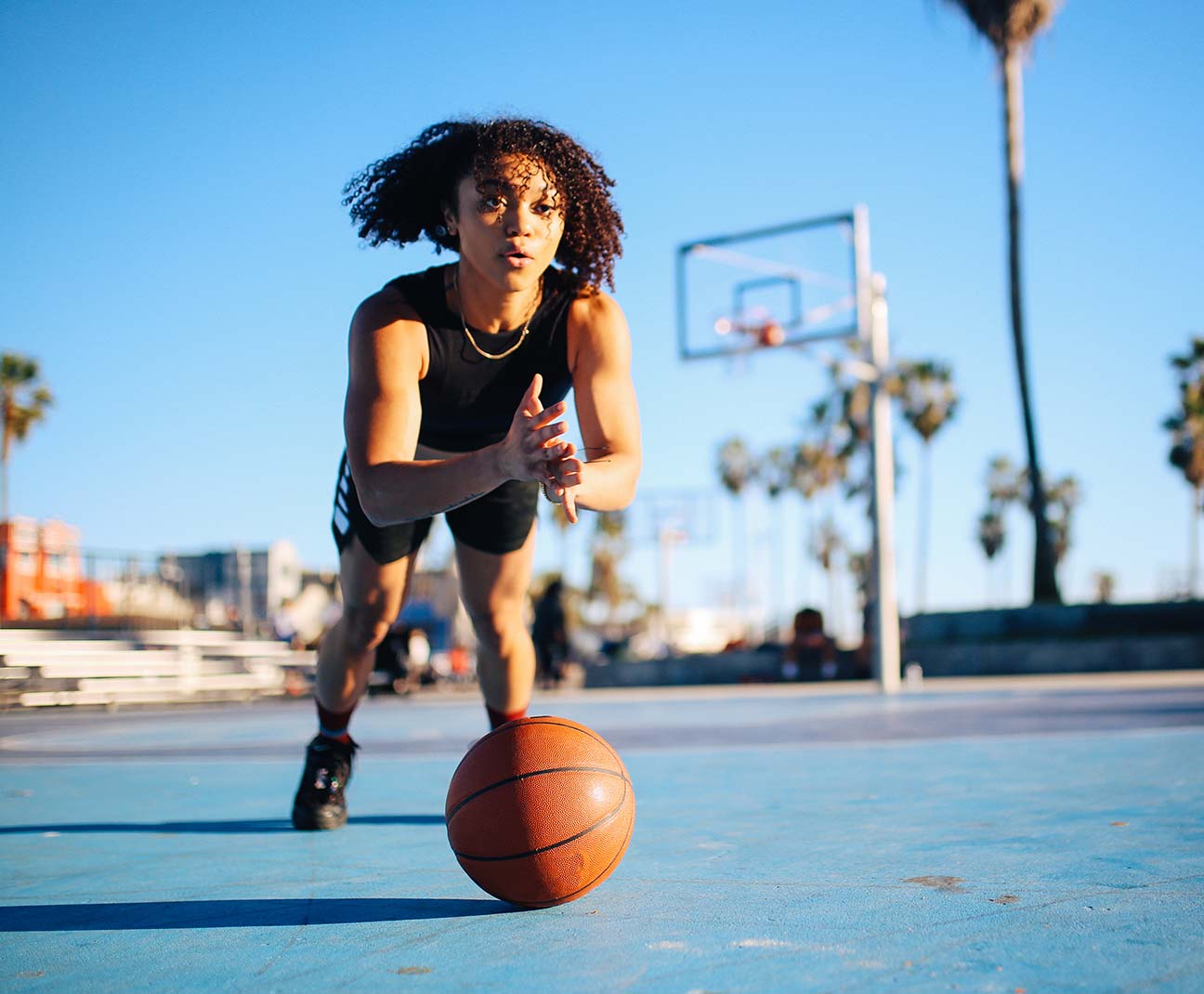 Woman reaching for a basketball