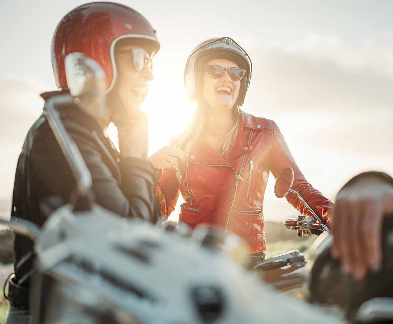 women standing by motorcycles