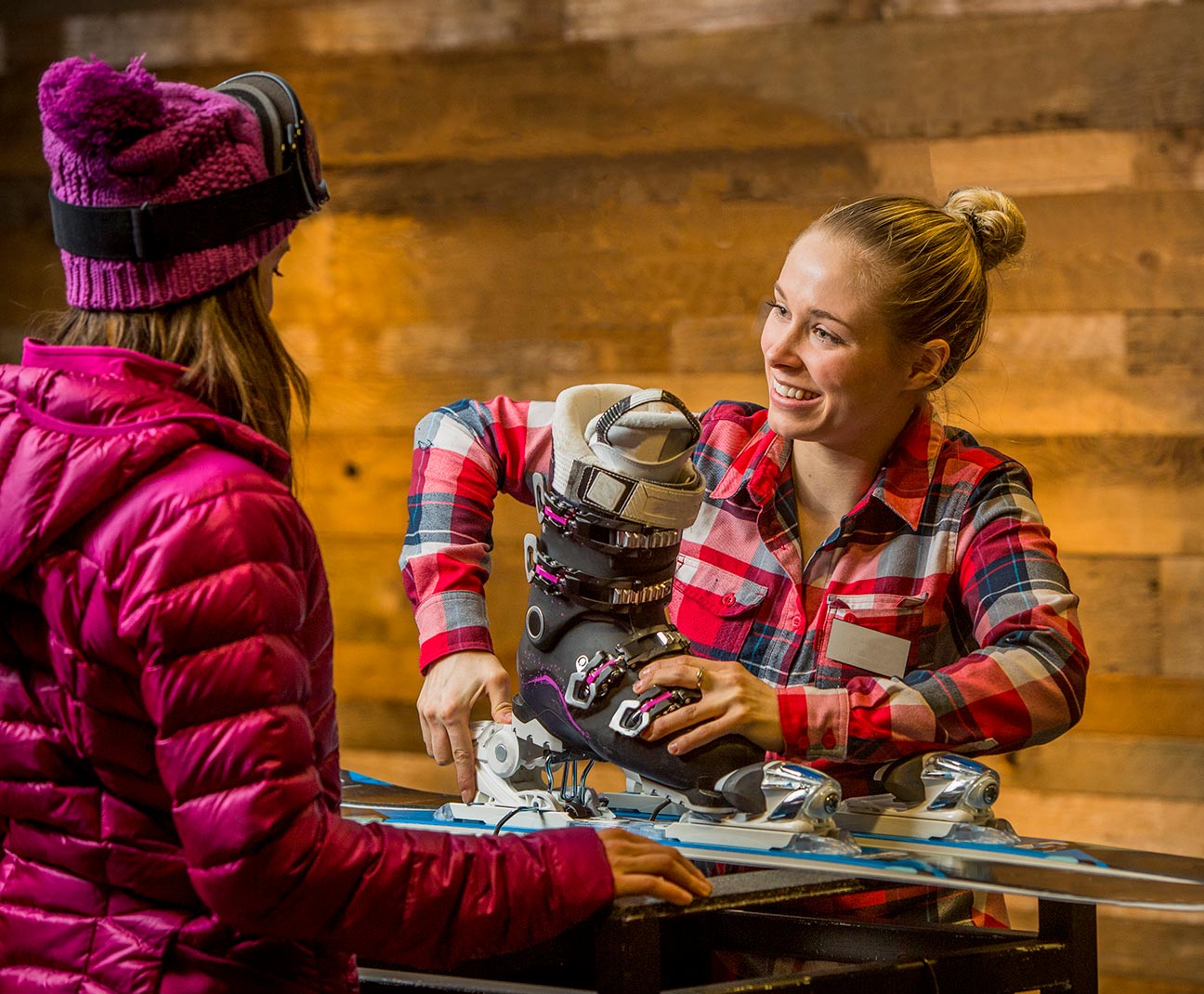 Ski shop employee setting up skis