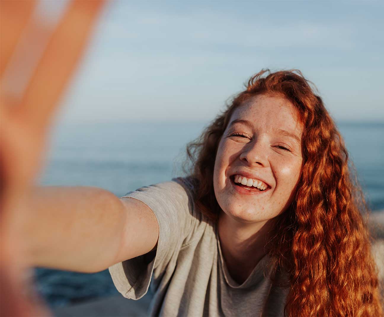 Happy young girl taking selfie