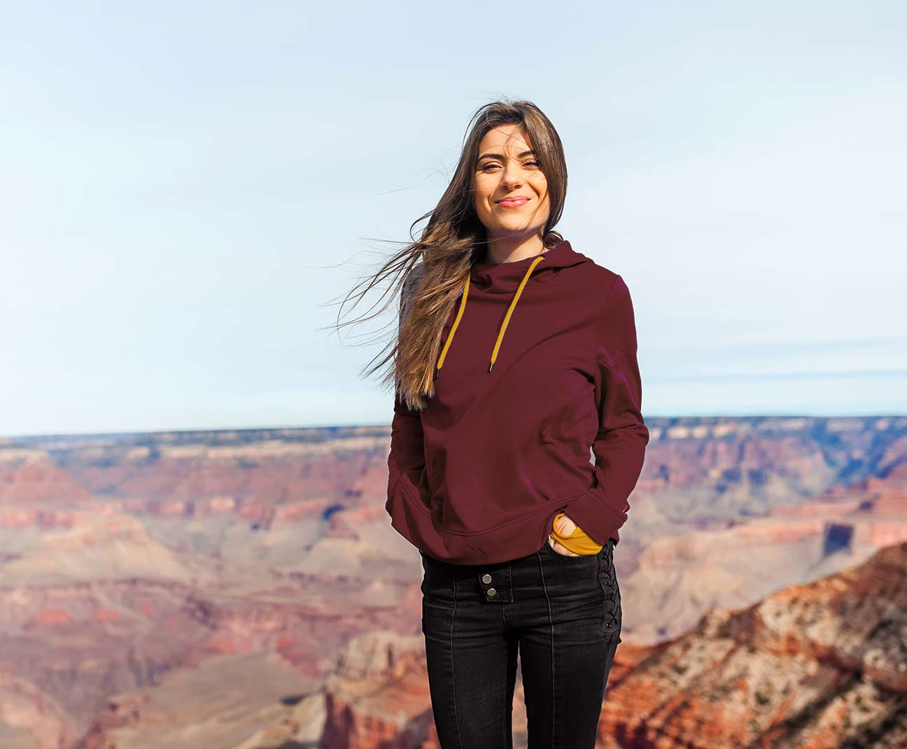 Young woman standing by the Grand Canyon