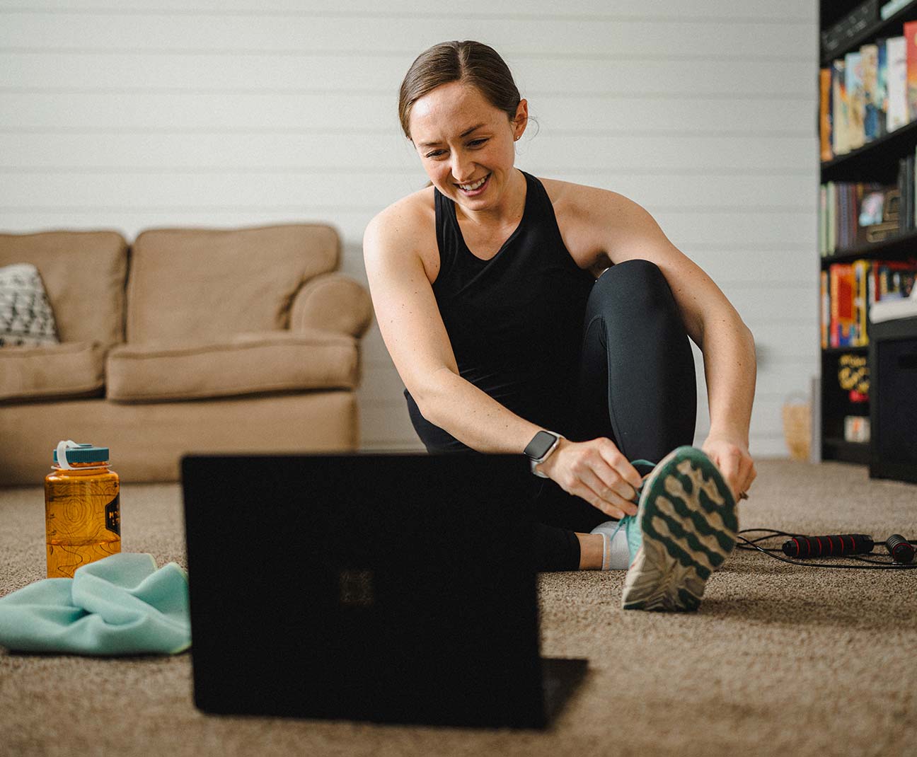 Woman is working out in her living room