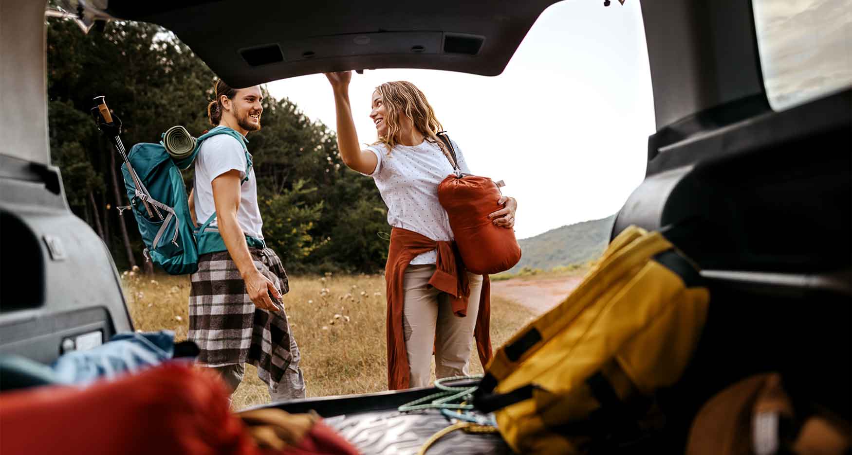 couple opening the trunk of their SUV