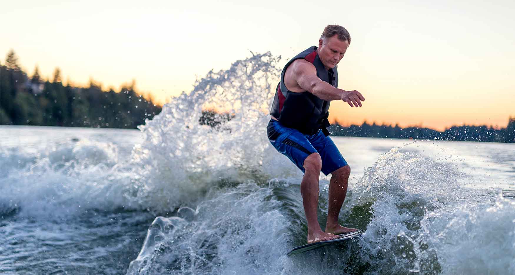 Man surfing behind a boat