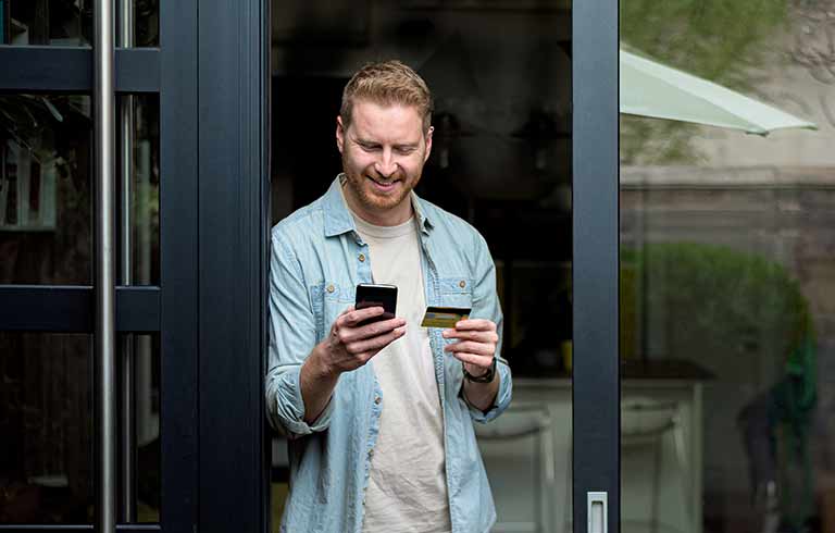 Man looking at a credit card