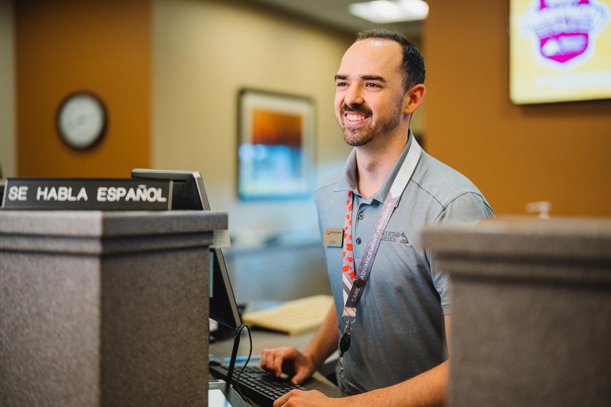 Male Mountain America team member enjoying work