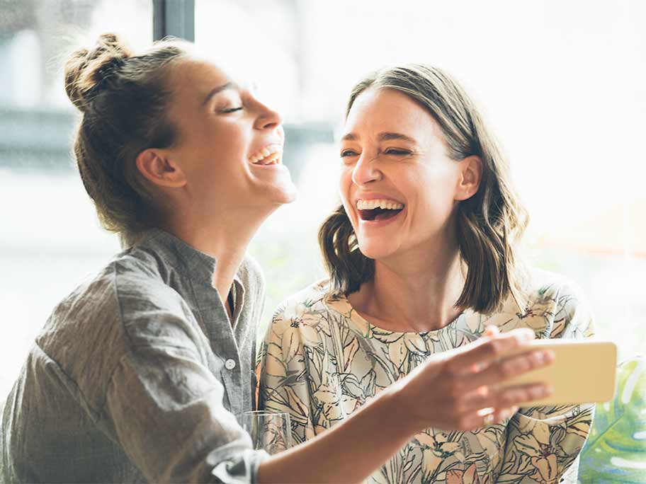 Two women watching video on phone