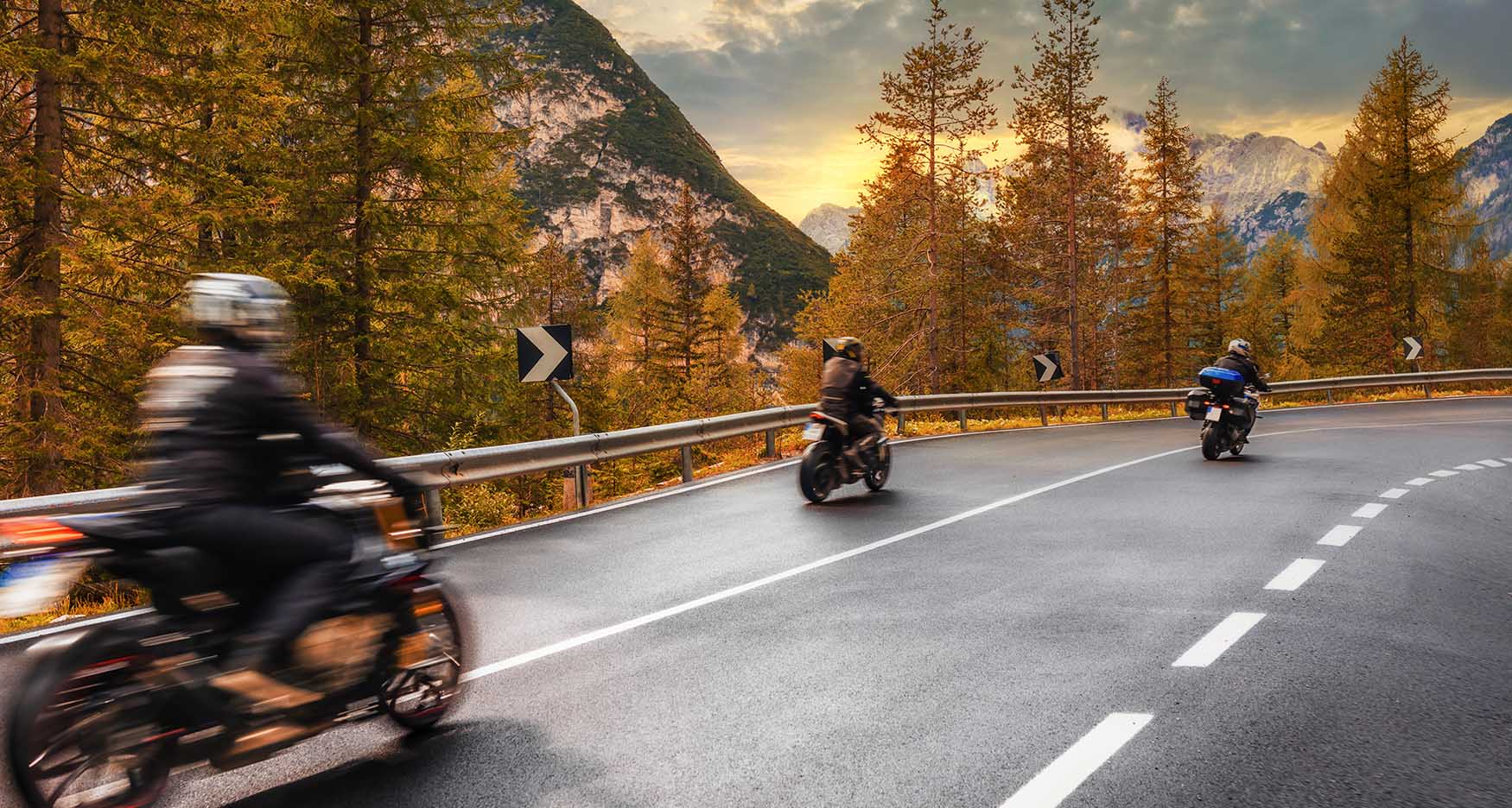 group of motorcyclists riding through the mountains