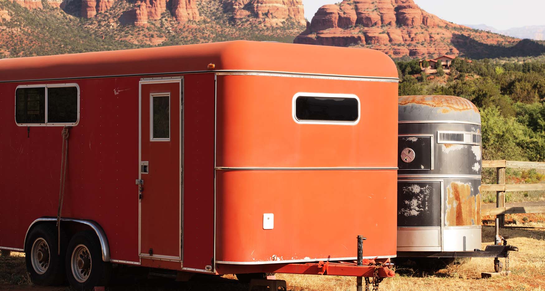 horse trailers with red rock in the background