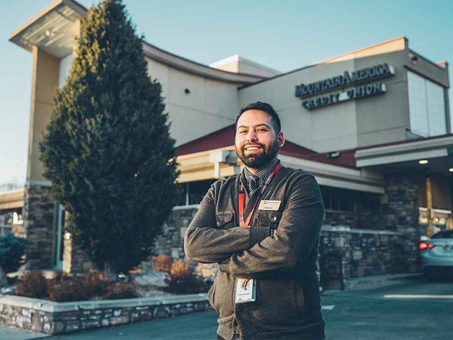 Proud employee in front of building