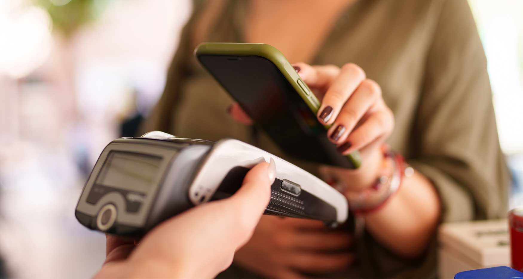 Woman using tap to pay on her phone