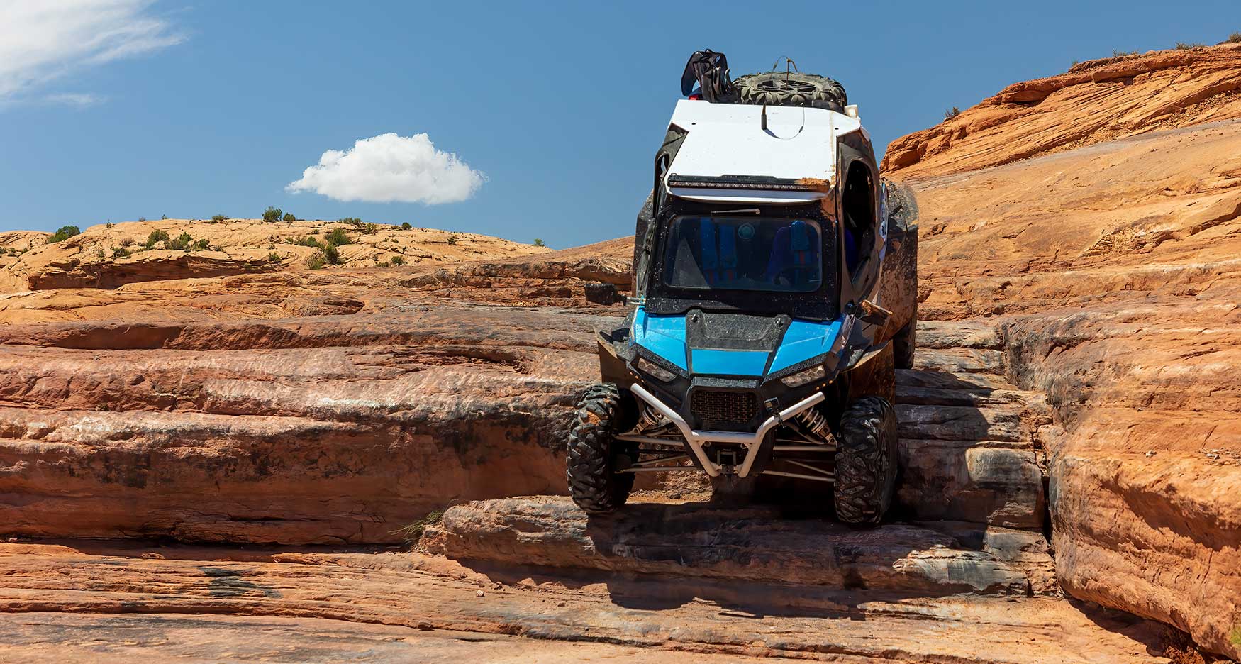 UTV driving down steep rocks