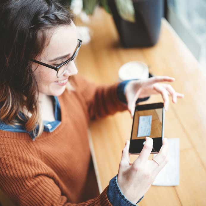 Woman depositing a check with her smartphone