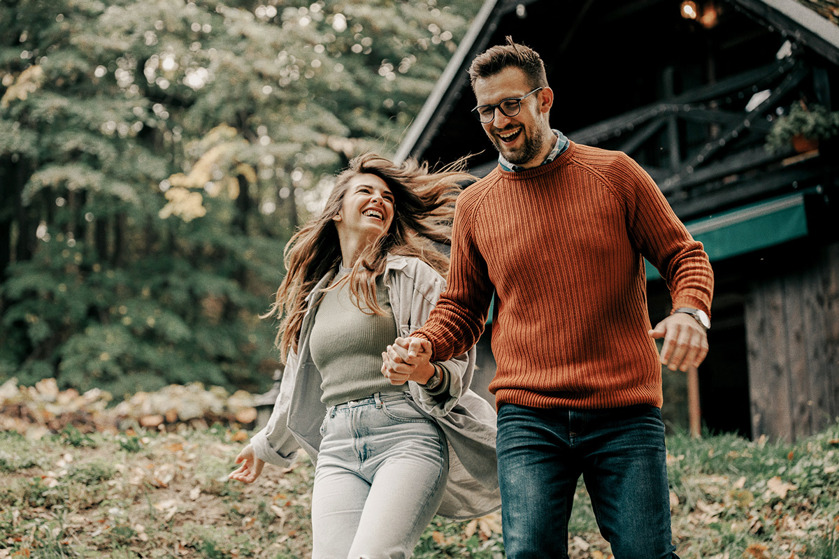 couple in front of mountain home