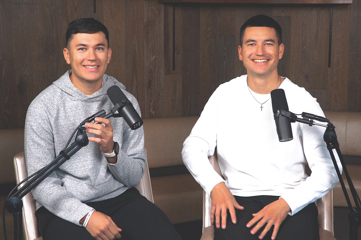 two young male athletes at the podcast mic