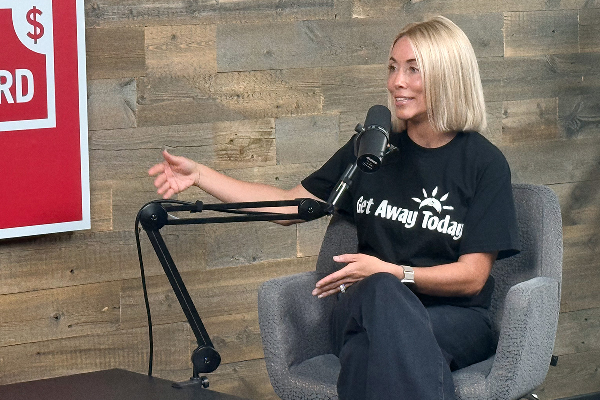 blond woman with black t-shirt sitting at podcast mic