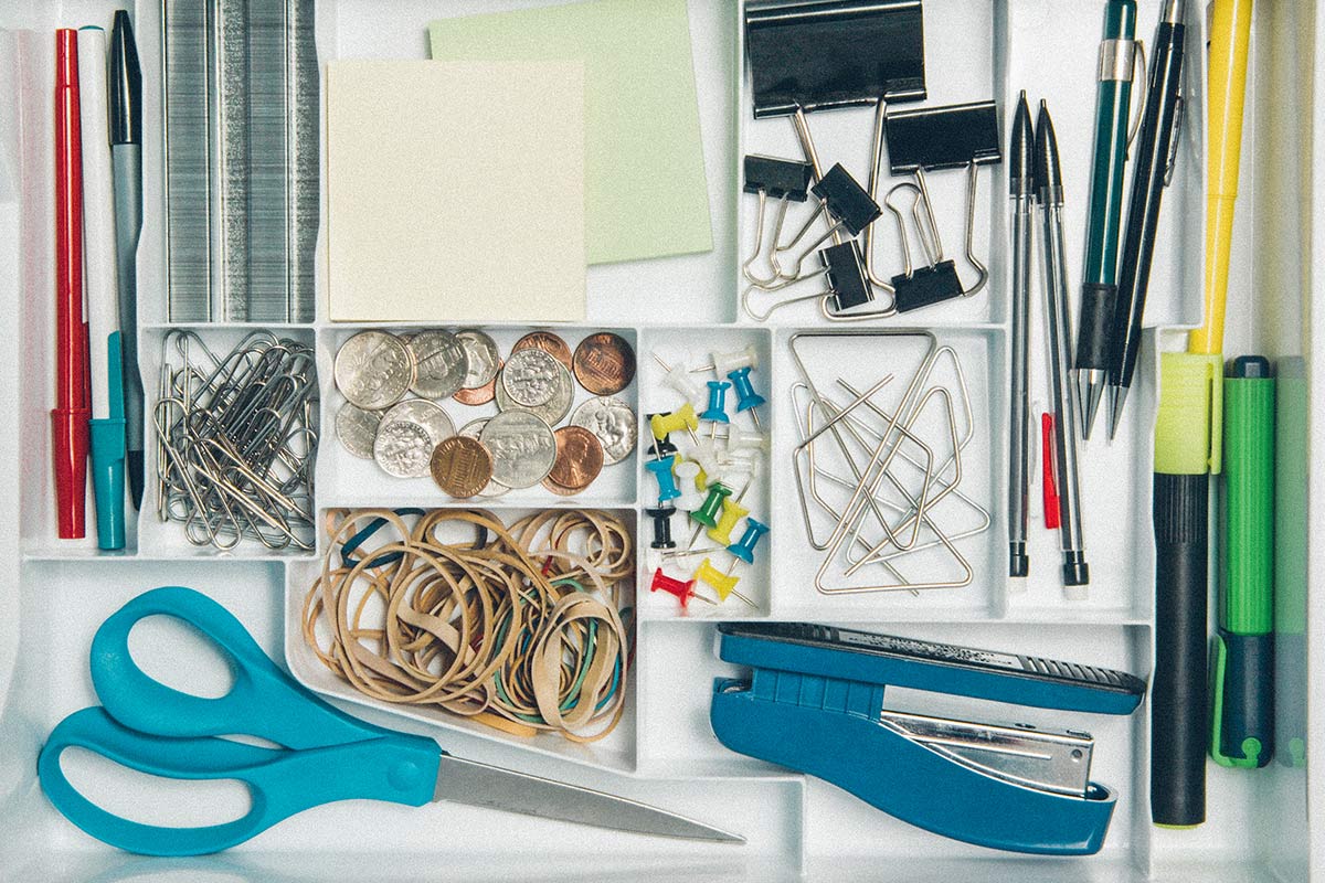 organized junk drawer with a variety of office supplies