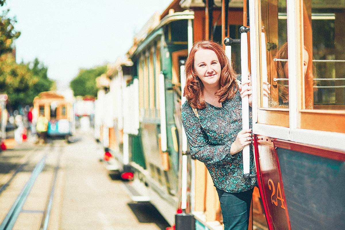 woman looking out of a train door