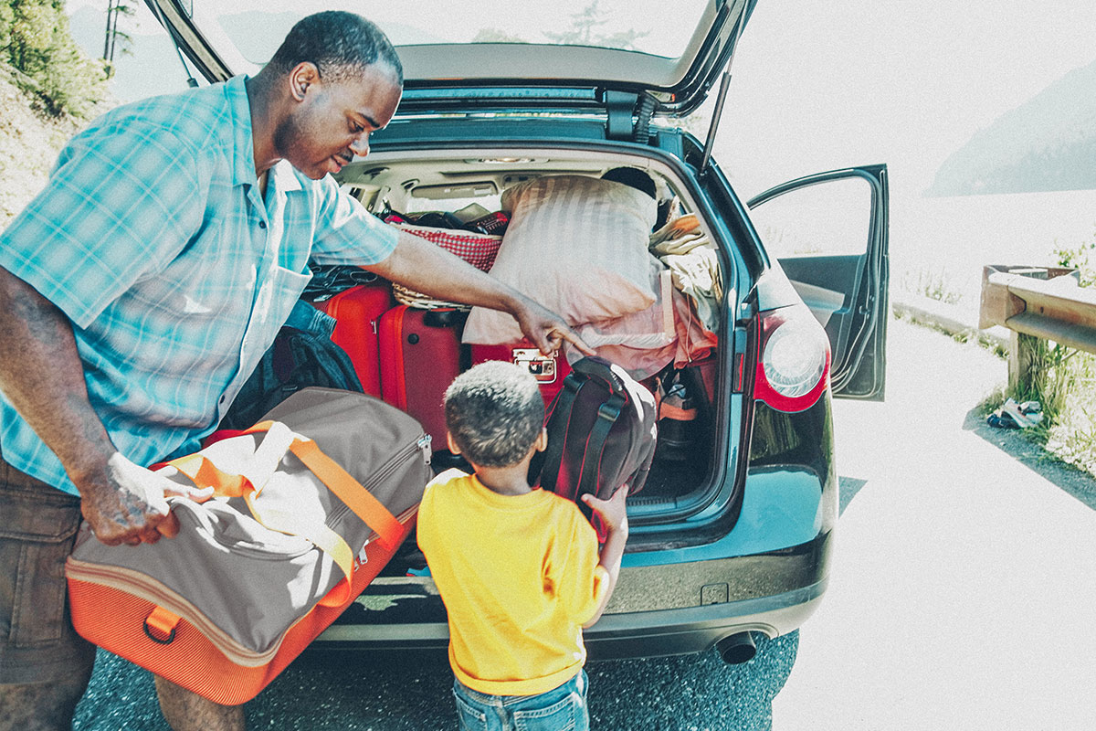 father and son loading the car for a raodtrip