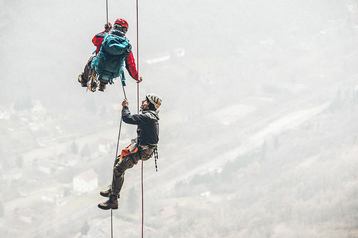 two people hanging on ropes for rock climbing