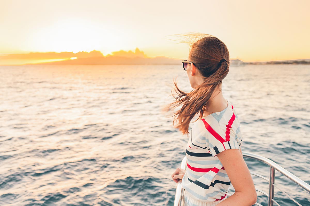 woman looking off the edge of a boat